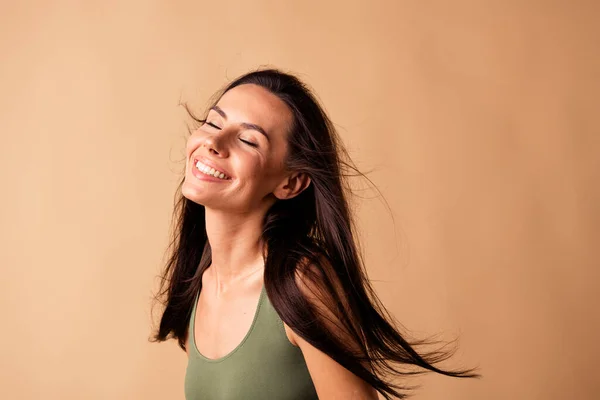 Photo of joyful lady smiling enjoying hairstyle purity after applying balm lotion isolated pastel color background.
