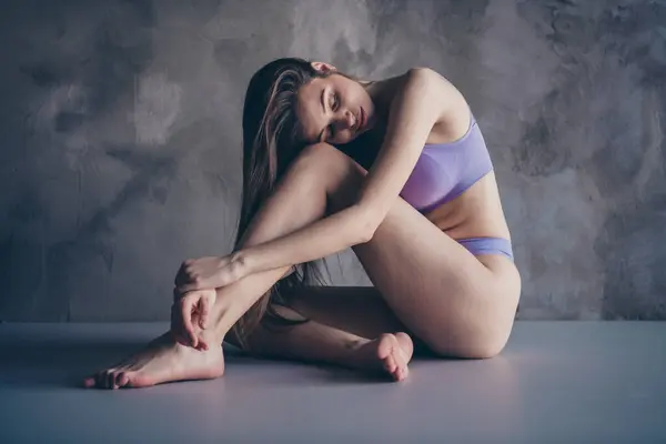 Aesthetic tender model girl photo advertisement basic comfortable underwear for women on grey wall background.