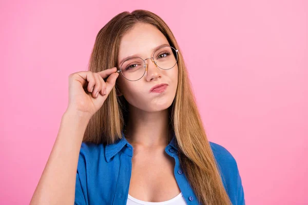 Photo of suspicious funky lady dressed blue shirt arm eyewear empty space isolated pink color background.