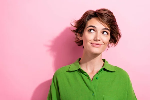 Photo of dreamy excited lady wear green shirt looking empty space isolated pink color background.