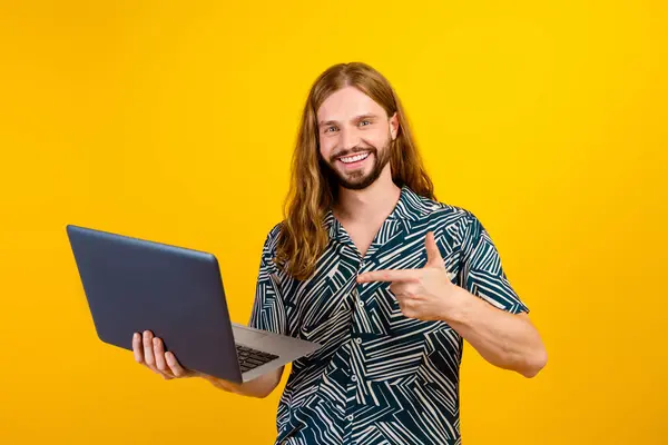 Photo of positive cool guy wear print shirt showing finger apple samsung modern device isolated yellow color background.