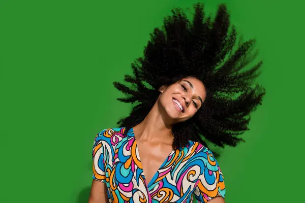 stock image Portrait of charming lovely young girl toothy smiling flying wavy hairdo wearing vintage blouse isolated on green color background.