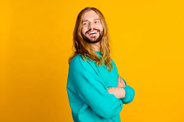 Profile photo of positive minded man toothy smile folded arms look empty space isolated on yellow color background.