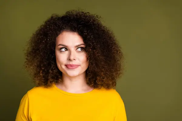 Portrait of gorgeous young sweet woman curly hair wear yellow shirt looking novelty dreamy expectations isolated on khaki color background.
