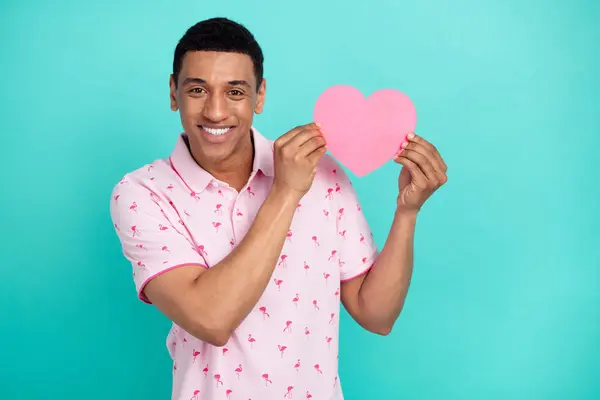 stock image Photo of satisfied handsome guy dressed casual polo holding paper heart postcard on valentine day isolated on teal color background.