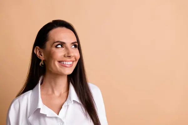 Photo of positive nice corporate lady beaming smile look empty space brainstorming isolated on beige color background.
