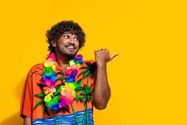 穿着夏威夷花项链的快乐小伙子的画像 直指出售用黄色背景隔开的空旷空间 — 图库照片