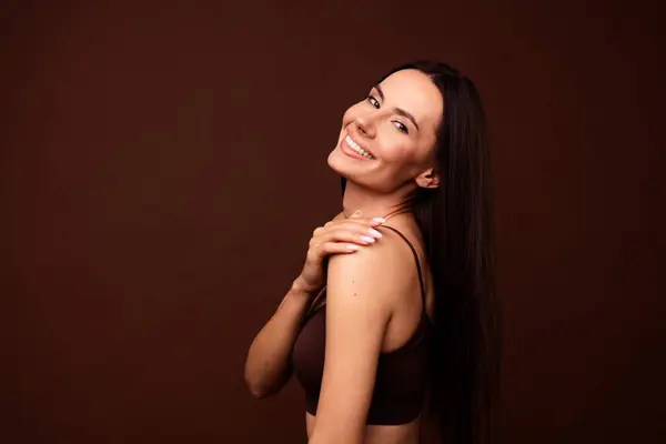Profile portrait of stunning lovely lady hand touch shoulder empty space ad isolated on brown color background.