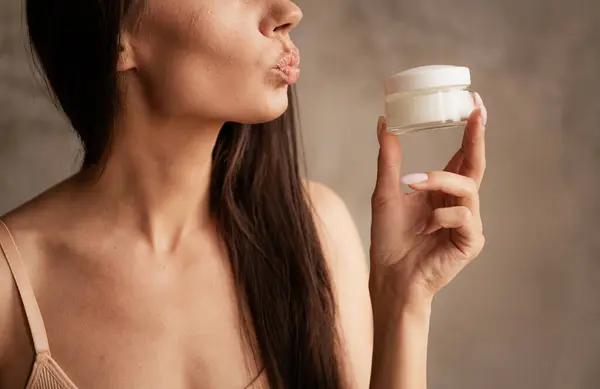 Side profile cropped photo of beauty industry advertisement woman plump kiss jar cream for detox isolated on gray color background.