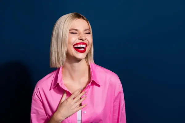 Photo of good mood adorable girl with bob hairstyle red lipstick dressed pink shirt laughing isolated on dark blue color background.