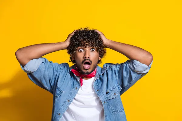 stock image Photo portrait of attractive young man touch head shocked face wear trendy denim clothes red scarf isolated on yellow color background.