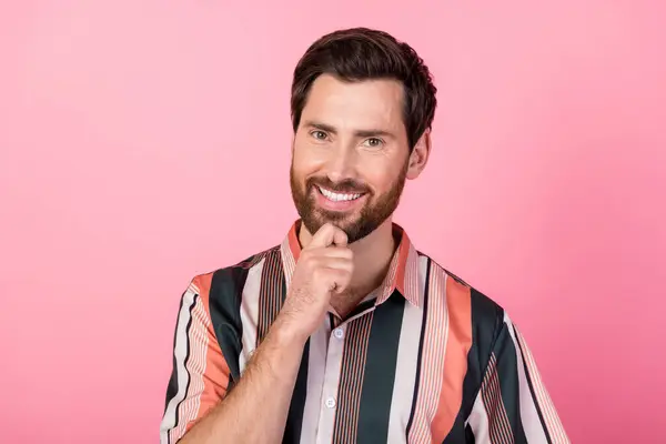 Portrait of positive nice young man beaming smile arm touch chin ponder solution isolated on pink color background.