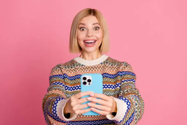 Photo of impressed girl with bob hair wear ornament sweater astonsihed staring on fast internet speed isolated on pink color background.
