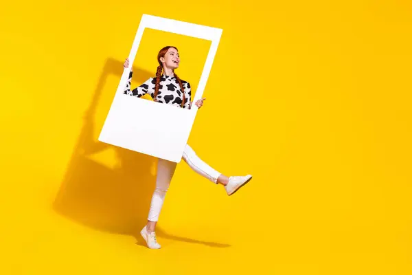 stock image Full length portrait of charming overjoyed person hold set album card dance empty space ad isolated on yellow color background.