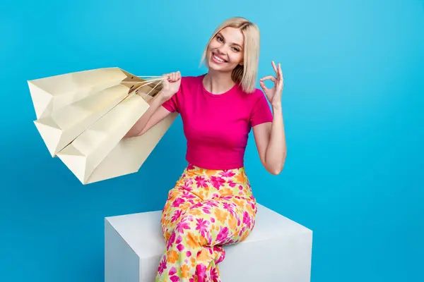 Photo Portrait Attractive Young Woman Sit Cube Shopping Bags Show — стоковое фото