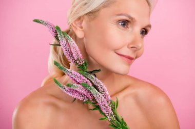 Photo of gorgeous pretty senior woman with fresh blooming flowers perfume smell shower gel balm isolated on pink color background. clipart