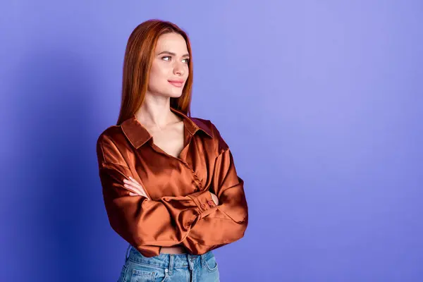 Photo of pretty young woman folded arms look empty space wear brown shirt isolated on violet color background.