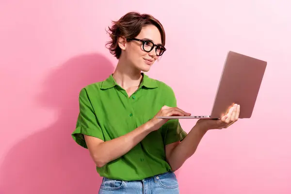 stock image Photo of thoughtful shiny young lady wear green shirt spectacles texting instagram twitter telegram facebook isolated pink color background.