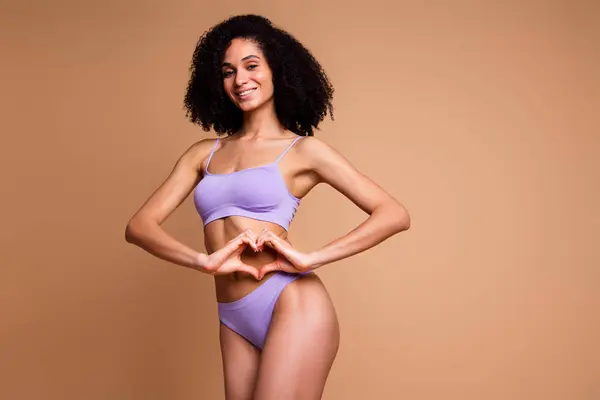 stock image Unretouched photo of pretty model girl show heart symbol isolated on beige color background.