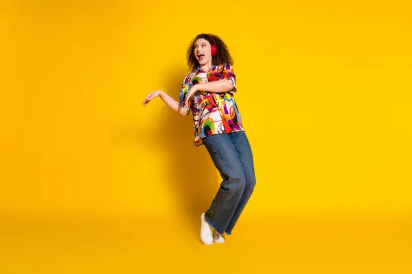 stock image Full length photo of lovely young lady dance tiptoes headphones dressed stylish colorful print garment isolated on yellow color background.