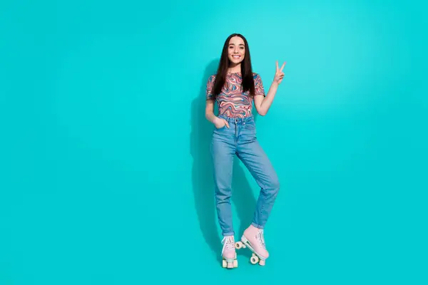 stock image Full length photo of charming girly woman wear print shirt riding rollers showing v-sign empty space isolated turquoise color background.