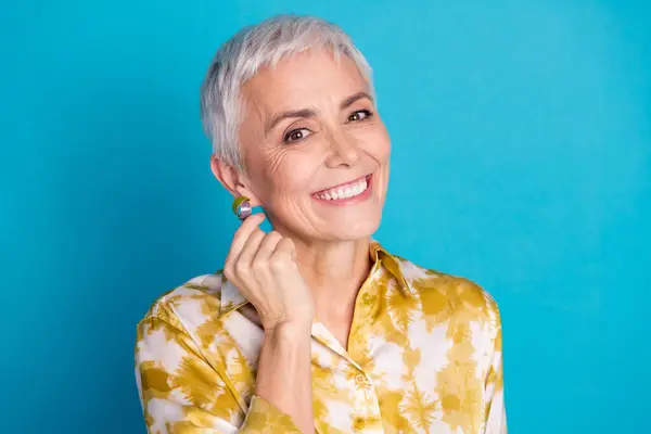 stock image Photo portrait of lovely pensioner lady touch earring dressed stylish elegant garment isolated on blue color background.