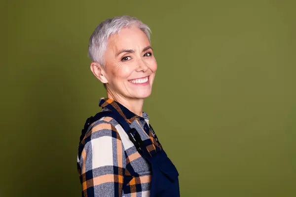 stock image Photo of pretty senior female professional expert handyman toothy smile wear blue workwear overall isolated on khaki color background.