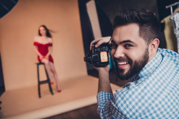 stock image Fashion photographer taking picture of attractive sexy woman photosession in modern studio indoors.