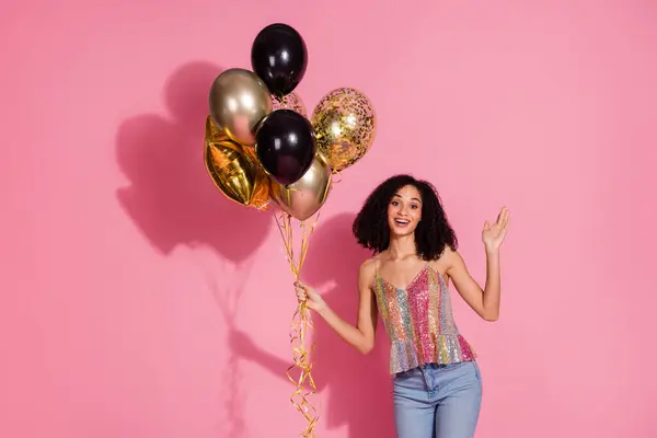 stock image Photo portrait of attractive young woman hold air balloons wave hand hi dressed stylish sequins clothes isolated on pink color background.