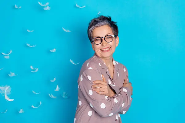 stock image Photo of adorable lovely cute senior woman wear stylish sleepwear hug herself empty space isolated on blue color background.