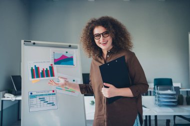 Photo of confident worker charming successful woman presenting statistics diagram office indoors. clipart