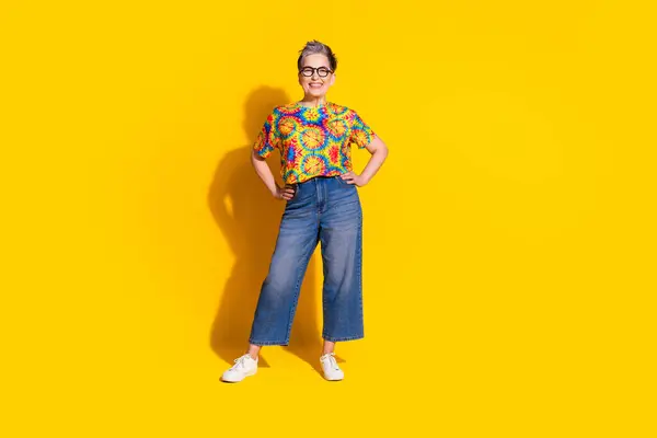 stock image Photo of cheerful glad senior woman wear stylish print clothes empty space isolated on vivid yellow color background.