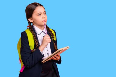 Close up side profile photo beautiful she her little lady hands arms pen chin notebook note information teacher ponder wear formalwear shirt blazer school form bag isolated bright orange background. clipart