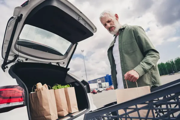 stock image Photo of funky cool mature guy dressed casual shirt riding auto enjoying grocery shopping outdoors urban city street.