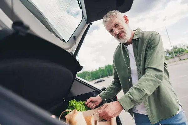 stock image Photo of funky cool mature guy dressed casual shirt riding auto enjoying grocery shopping outdoors urban city street.