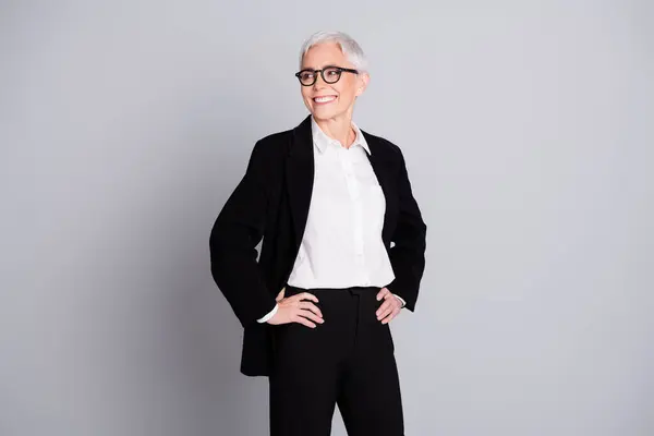 stock image Photo portrait of lovely pensioner lady startup boss confident look empty space dressed formalwear specs isolated on gray color background.