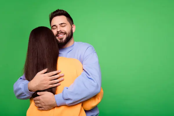 stock image Back view photo of charming lovely couple wear stylish clothes empty space isolated on green color background.