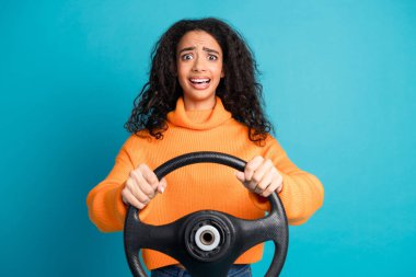 Photo of pretty young girl hold wheel wear orange pullover isolated on teal color background. clipart