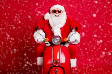 Feel young. Photo of retired grandpa white beard ride retro moped fast exceed speed limit empty highway adrenaline wear x-mas costume coat sunglass cap isolated red color background clipart