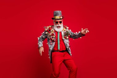 Photo of santa claus funny man dance good mood dressed christmas tree balls costume sunglasses isolated red color background. clipart