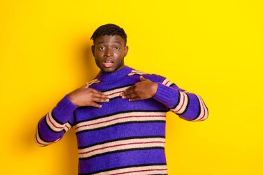 Portrait of nice young man arms touch chest wear sweater isolated on yellow color background. clipart