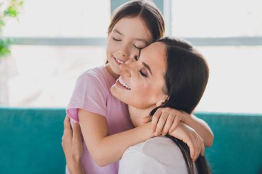 Photo of lovely adorable mother with daughter spending time together family relationship indoors living room. clipart