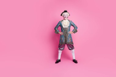 A person dressed in a baroque-style costume stands against a pink backdrop. The attire suggests a luxurious and aristocratic theme, suitable for a masquerade or historical event. clipart