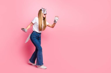 A young girl wearing a cat mask and gloves stands against a pink background, embodying creativity, cosplay culture, and unique expressions of individual identity and style. clipart