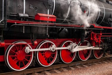KYIV, UKRAINE - JANUARY 8, 2023: Vintage locomotive of 1954 at the central railway station. Retro train wheels.