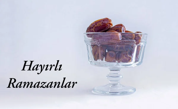 Hayirli Ramazanlar (Translate: Happy Ramadan). Date fruits in bowl with copy space. Muslims holy month Ramadan.
