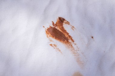 Chocolate stain on white shirt. Top view dirty t shirt.