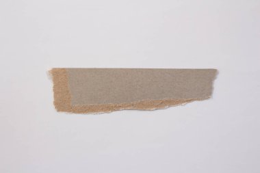 Blank torn cardboard isolated on white background. Top view of carton piece with copy space.