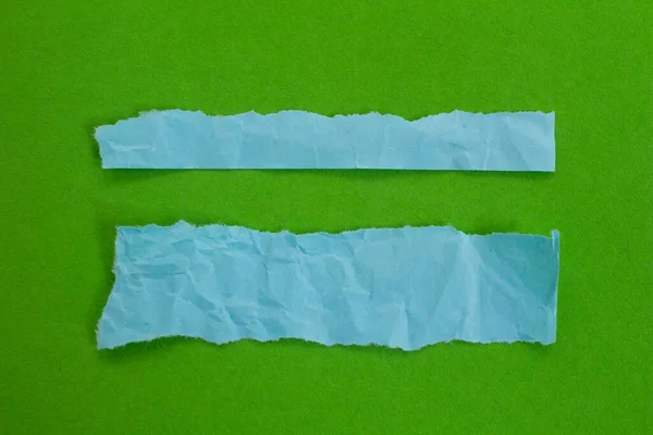Set of blue torn paper isolated on green background with copy space.