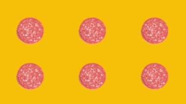 Slice of sucuk rotation on yellow background. Turkish meat product sucuk.